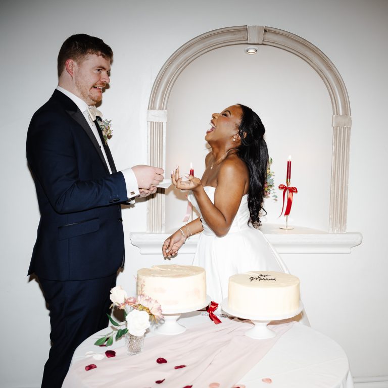 bride & groom laughing duringthe cake cutting at the wedding - Documentary Wedding Photographer London